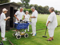 August Tournament: Paul Castell, temping as Trolly Dolly, in action - punishment for tp-ing the Manager. Includes Wendy Spencer-Smith, Quiller Barrett and Chris Constable
